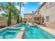 Inviting backyard pool and spa with lush landscaping and covered patio, great for entertaining at 7715 Villa De La Paz Ave, Las Vegas, NV 89131