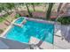 Aerial view of a backyard pool and spa with stone trim, trees, and privacy walls at 7715 Villa De La Paz Ave, Las Vegas, NV 89131