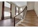 Staircase leading to second floor with dark metal railing overlooking a bright living space at 7715 Villa De La Paz Ave, Las Vegas, NV 89131