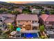 Beautifully landscaped backyard featuring a pool, spa, covered patio, and lush greenery, as seen from an aerial view at 8429 Brackenfield Ave, Las Vegas, NV 89178