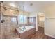 Bright bathroom featuring a glass shower, soaking tub, and a view into the walk-in closet at 8429 Brackenfield Ave, Las Vegas, NV 89178