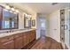 Bathroom featuring double sinks, wood cabinets, granite countertops, and a walk-in shower at 8429 Brackenfield Ave, Las Vegas, NV 89178