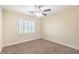 Neutral bedroom features a ceiling fan and a window with white shutters at 8429 Brackenfield Ave, Las Vegas, NV 89178