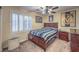 Bedroom with plantation shutters, ceiling fan, and wood furniture at 8429 Brackenfield Ave, Las Vegas, NV 89178