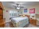 This cozy bedroom offers a ceiling fan, plantation shutters, and wood furniture at 8429 Brackenfield Ave, Las Vegas, NV 89178