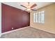 Bedroom with a dark accent wall, ceiling fan, and window with blinds at 8429 Brackenfield Ave, Las Vegas, NV 89178