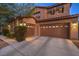 Two-story home with well-manicured landscaping, and a three-car garage at 8429 Brackenfield Ave, Las Vegas, NV 89178