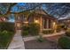 Two-story home with landscaped front yard, mature trees, stone accents and gated entrance at 8429 Brackenfield Ave, Las Vegas, NV 89178