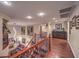 Open hallway with decorative railing overlooking living room with fireplace and tall ceilings at 8429 Brackenfield Ave, Las Vegas, NV 89178