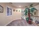 Hallway with art and an indoor plant. Carpeted floors at 8429 Brackenfield Ave, Las Vegas, NV 89178