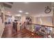 Beautiful hallway with wood flooring, ornate iron railing, and open view of living area at 8429 Brackenfield Ave, Las Vegas, NV 89178