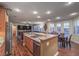 Open kitchen with granite countertops, stainless steel appliances, breakfast bar, and seamless living area flow at 8429 Brackenfield Ave, Las Vegas, NV 89178