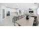 Modern kitchen with a large island and dining area with sleek chairs and bright lighting create an inviting atmosphere at 8429 Brackenfield Ave, Las Vegas, NV 89178