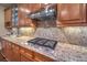 Gourmet kitchen features stainless steel appliances, granite countertops, custom cabinetry, and modern vent hood at 8429 Brackenfield Ave, Las Vegas, NV 89178