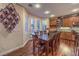 Bright kitchen and dining area featuring wood floors, cabinetry, and a dining table, perfect for Gathering meals at 8429 Brackenfield Ave, Las Vegas, NV 89178