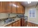 Laundry room with wood cabinets, granite counters, and a stainless-steel washer and dryer at 8429 Brackenfield Ave, Las Vegas, NV 89178