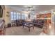 Open-concept living room with hardwood, plush seating, a decorative fireplace, and seamless kitchen transition at 8429 Brackenfield Ave, Las Vegas, NV 89178