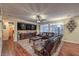 Spacious living room with hardwood floors, plush seating, custom entertainment center, and bright natural light at 8429 Brackenfield Ave, Las Vegas, NV 89178