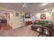 Comfortable living room featuring carpet, a plush sofa, and built in media center at 8429 Brackenfield Ave, Las Vegas, NV 89178