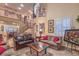 Bright and spacious living room with soaring ceilings, fireplace, and a view of the second-floor balcony at 8429 Brackenfield Ave, Las Vegas, NV 89178