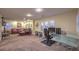 Expansive living room with comfortable seating, media center, and natural light from shuttered windows at 8429 Brackenfield Ave, Las Vegas, NV 89178