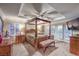 Luxurious primary bedroom with a tray ceiling, plush carpet, and a private balcony at 8429 Brackenfield Ave, Las Vegas, NV 89178