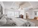 Comfortable bedroom features a fireplace, plantation shutters, and tray ceilings at 8429 Brackenfield Ave, Las Vegas, NV 89178
