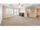 Large main bedroom featuring a ceiling fan, balcony access, and an electric fireplace at 8429 Brackenfield Ave, Las Vegas, NV 89178