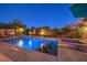 Inviting pool featuring in-pool seating, a spa, and fire features nestled within a landscaped backyard for ultimate relaxation at 8429 Brackenfield Ave, Las Vegas, NV 89178