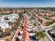 High-angle view of the community showcasing tree-lined streets, desert landscaping, and red tiled roofs at 8552 Desert Holly Dr, Las Vegas, NV 89134