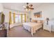 Comfortable bedroom features a large window with natural light and a ceiling fan at 8552 Desert Holly Dr, Las Vegas, NV 89134