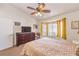 Cozy bedroom with a ceiling fan, large dresser, and a bright window at 8552 Desert Holly Dr, Las Vegas, NV 89134
