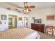 Spacious bedroom with a ceiling fan, large dresser, and access to a bathroom at 8552 Desert Holly Dr, Las Vegas, NV 89134