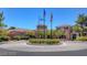 Welcoming clubhouse with landscaped grounds and flags, creating a vibrant community hub for residents at 8552 Desert Holly Dr, Las Vegas, NV 89134
