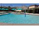Refreshing community pool featuring multiple levels, shade umbrellas, and comfortable lounge seating for residents' enjoyment at 8552 Desert Holly Dr, Las Vegas, NV 89134