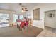 Carpeted dining area features a sliding glass door, ceiling fan and decorative wall hangings at 8552 Desert Holly Dr, Las Vegas, NV 89134