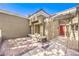 Charming home entrance featuring a red front door, and a cozy brick-paved patio under a clear, blue sky at 8552 Desert Holly Dr, Las Vegas, NV 89134
