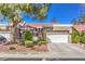 Charming home featuring a well-maintained front yard, mature tree, and a two-car garage with a paved driveway at 8552 Desert Holly Dr, Las Vegas, NV 89134