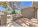 Cozy front yard featuring a brick-paved patio, seat, and secure privacy fence at 8552 Desert Holly Dr, Las Vegas, NV 89134