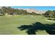 Scenic view of the lush golf course with mature trees and mountain views at 8552 Desert Holly Dr, Las Vegas, NV 89134