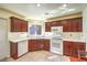 Modern kitchen featuring dark wood cabinets, white countertops, and stainless steel appliances at 8552 Desert Holly Dr, Las Vegas, NV 89134
