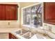 Bright kitchen features stainless steel sink, quartz countertops, and ample cabinet space at 8552 Desert Holly Dr, Las Vegas, NV 89134