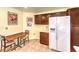Cozy kitchen with a refrigerator, and an adjacent dining area at 8552 Desert Holly Dr, Las Vegas, NV 89134