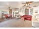 Spacious living room with ceiling fans, a carpeted floor, and lots of natural light at 8552 Desert Holly Dr, Las Vegas, NV 89134