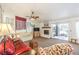 Bright living room featuring a ceiling fan, a fireplace and a sliding glass door at 8552 Desert Holly Dr, Las Vegas, NV 89134
