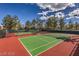 Well-maintained tennis courts surrounded by lush trees and a clear blue sky at 8552 Desert Holly Dr, Las Vegas, NV 89134