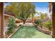 Secluded backyard featuring mature shade tree, manicured lawn, and privacy landscaping at 8851 Quintane Ln, Las Vegas, NV 89123