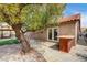 A peaceful backyard with lush landscaping including trees, a gazebo and a barbeque area at 8851 Quintane Ln, Las Vegas, NV 89123