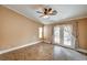 Bright bedroom with French doors and decorative ceiling fan at 8851 Quintane Ln, Las Vegas, NV 89123