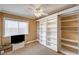 This bedroom features neutral walls, carpeted floors, and a built in bookcase at 8851 Quintane Ln, Las Vegas, NV 89123
